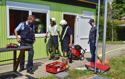 Bürgermeister und Polizei betrachten die verbrannte Thermobox. FOTO: MEYER