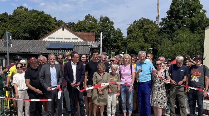 Tübinger OB Boris Palmer (hellblaues Hemd) eröffnet gemeinsam mit Anwohnern und Mitwirkenden die neue Brücke.